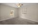 Bright bedroom with carpeted floor, ceiling fan, and built-in shelving at 213 W Lady Lake Blvd, Lady Lake, FL 32159