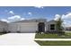 Charming single-story home boasts a well-manicured lawn and a two-car garage in a suburban neighborhood at 3092 Canopy Oak Blvd, Wildwood, FL 34785