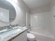 Clean bathroom with granite countertop, white vanity, and bathtub at 7 Teak Loop Pl, Ocala, FL 34472