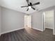 Bedroom with wood-look floors, ceiling fan, and closet at 7 Teak Loop Pl, Ocala, FL 34472