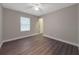 Bright bedroom featuring wood-look floors and ceiling fan at 7 Teak Loop Pl, Ocala, FL 34472