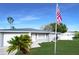 Newly renovated home with gray exterior, landscaping, and American flag at 7 Teak Loop Pl, Ocala, FL 34472