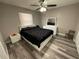 Bedroom featuring modern décor, wood floors, ceiling fan, and natural light at 8788 Se 88Th Pl, Ocala, FL 34472