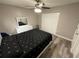 Well-lit bedroom with wood floors, ceiling fan, and spacious closet at 8788 Se 88Th Pl, Ocala, FL 34472
