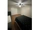 Cozy bedroom with wood floors, ceiling fan, and closet space at 8788 Se 88Th Pl, Ocala, FL 34472