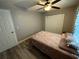 Bedroom featuring modern décor, wood floors, ceiling fan, and closet at 8788 Se 88Th Pl, Ocala, FL 34472