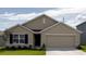 Charming single-story home featuring a two-car garage, well-manicured lawn, and beautiful landscaping at 8878 Sw 48Th Ave, Ocala, FL 34476
