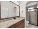 Bathroom featuring a dual sink vanity with granite counters and walk-in shower at 3907 Se 10Th Ave, Ocala, FL 34480