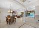 Spacious dining room with coffered ceilings, tile floors, and a view of the kitchen and pool area at 3907 Se 10Th Ave, Ocala, FL 34480