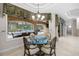 Breakfast nook featuring a chandelier and views of the screened lanai and pool area at 3907 Se 10Th Ave, Ocala, FL 34480