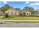 Charming single-story home with mature landscaping, lush green lawn, and brick and stone accents at 3907 Se 10Th Ave, Ocala, FL 34480