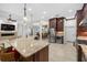 Open-concept kitchen with center island, stainless steel appliances, and views of the living and dining areas at 3907 Se 10Th Ave, Ocala, FL 34480