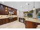 Gourmet kitchen with stainless appliances, granite counters, and custom cabinetry overlooking the pool at 3907 Se 10Th Ave, Ocala, FL 34480