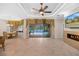 Spacious living room featuring travertine flooring, fireplace, and access to the pool area at 3907 Se 10Th Ave, Ocala, FL 34480
