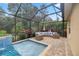 Screened in patio with a pool and spa with water feature and outside seating area at 3907 Se 10Th Ave, Ocala, FL 34480