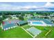 Aerial view of community with pool, tennis courts, shuffleboard, and clubhouse at 5520 Nw 26Th Ln, Ocala, FL 34482