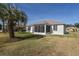 Home exterior showcasing screened porch and palm tree at 5520 Nw 26Th Ln, Ocala, FL 34482