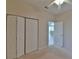 Bedroom with double door closet and access to other rooms at 5520 Nw 26Th Ln, Ocala, FL 34482