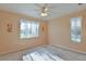 Bright bedroom with ceiling fan and window looking out to the yard at 5520 Nw 26Th Ln, Ocala, FL 34482