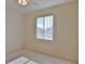 Bright bedroom with ceiling fan and window with blinds at 5520 Nw 26Th Ln, Ocala, FL 34482