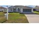 Single-story home with a two-car garage and landscaped lawn at 5520 Nw 26Th Ln, Ocala, FL 34482