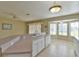 Kitchen with island, white cabinets, and bay window at 5520 Nw 26Th Ln, Ocala, FL 34482