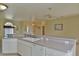Kitchen features island, double sink, and white cabinets at 5520 Nw 26Th Ln, Ocala, FL 34482
