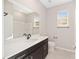Modern bathroom with dark vanity, white countertop, and a shower at 7781 Sw 59Th Ln, Ocala, FL 34474