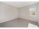 Simple bedroom with grey carpet and a window at 7781 Sw 59Th Ln, Ocala, FL 34474