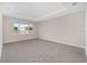 Spacious bedroom with plush carpeting and large window at 7781 Sw 59Th Ln, Ocala, FL 34474