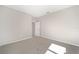 Spacious bedroom with grey carpet and a door to another room at 7781 Sw 59Th Ln, Ocala, FL 34474