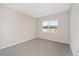 Simple bedroom with grey carpet and a window at 7781 Sw 59Th Ln, Ocala, FL 34474