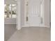 Bright entryway with tile flooring, white door, and view into adjacent room at 7781 Sw 59Th Ln, Ocala, FL 34474