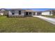 One story home with a two-car garage and a large front yard at 7781 Sw 59Th Ln, Ocala, FL 34474