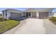 Two-car garage, light colored house with neutral colored trim at 7781 Sw 59Th Ln, Ocala, FL 34474