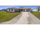 Single-story house with a two-car garage and a long driveway at 7781 Sw 59Th Ln, Ocala, FL 34474