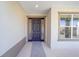 Dark brown front door with glass panels and sidelights at 7781 Sw 59Th Ln, Ocala, FL 34474
