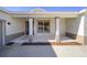 Covered front porch with columns and a dark front door at 7781 Sw 59Th Ln, Ocala, FL 34474