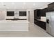 Modern kitchen with dark cabinetry, large island, and stainless steel appliances at 7781 Sw 59Th Ln, Ocala, FL 34474