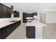 Modern kitchen with dark cabinets and expansive island at 7781 Sw 59Th Ln, Ocala, FL 34474