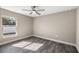 Bright bedroom with ceiling fan and wood-look flooring at 14462 Se 28Th Ct, Summerfield, FL 34491