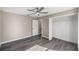 Bedroom with ceiling fan, wood-look flooring, and closet at 14462 Se 28Th Ct, Summerfield, FL 34491