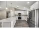 Modern kitchen with white cabinets and stainless steel appliances at 14462 Se 28Th Ct, Summerfield, FL 34491