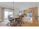 Dining area with a chandelier and a large sliding glass door with draped curtains at 1673 Belle Grove Dr, The Villages, FL 32162