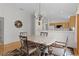 A dining room near the kitchen with an ornate mirror on the wall and hardwood floors at 1673 Belle Grove Dr, The Villages, FL 32162