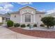 Charming single-story home with manicured landscaping, decorative stone, and architectural details at 1673 Belle Grove Dr, The Villages, FL 32162