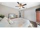 Neutral bedroom with a ceiling fan, carpeted floors, a large closet, and a sun-filled window at 17006 Sw 39Th Cir, Ocala, FL 34473