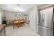 Dining room with a wooden table, chairs, and a stainless steel refrigerator at 17006 Sw 39Th Cir, Ocala, FL 34473