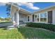 Charming front entrance featuring a cozy bench, stylish shutters, and well-maintained landscaping at 17006 Sw 39Th Cir, Ocala, FL 34473