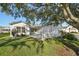Charming home featuring a well-manicured lawn and an inviting patio area, perfect for outdoor living at 2427 Due West Dr, The Villages, FL 32162